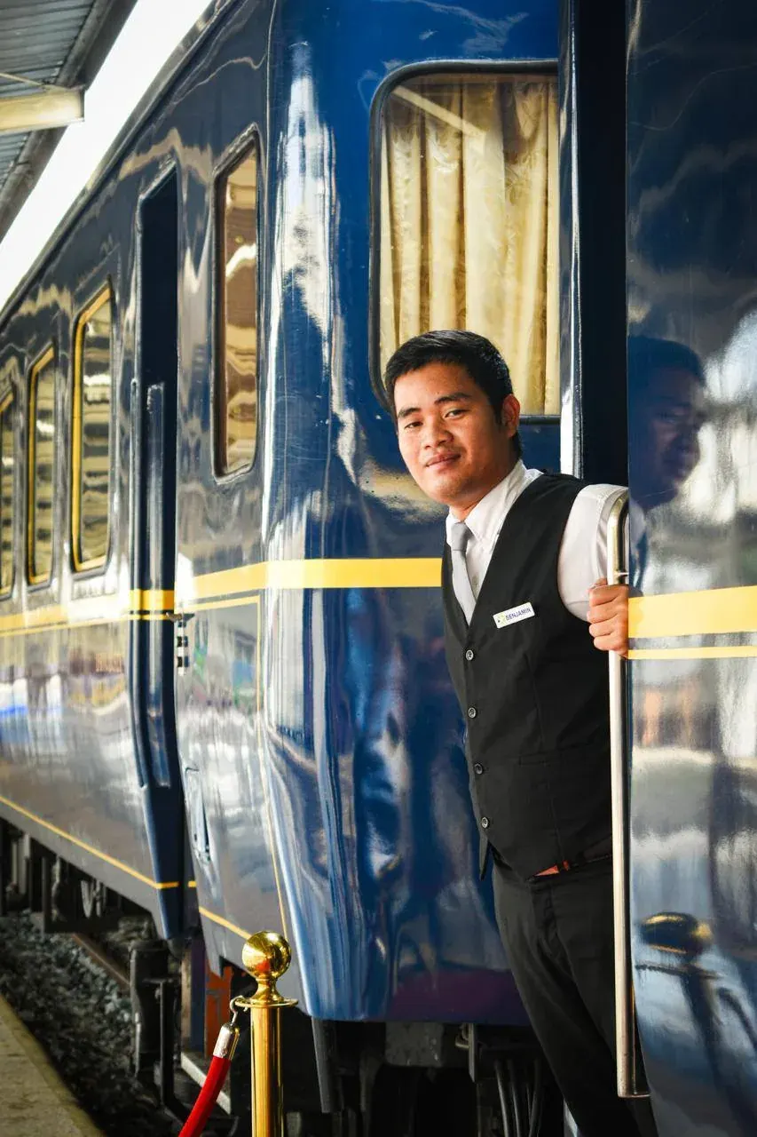 Man in business attire standing at the doorway of a train car Man in business attire standing at the doorway of a train car