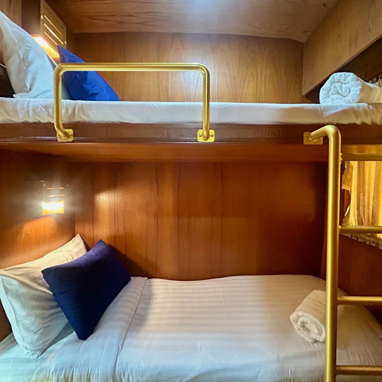 Cozy bunk bed cabin interior with brass rails and wood paneling, used as a calm backdrop for information on filing FBAR online