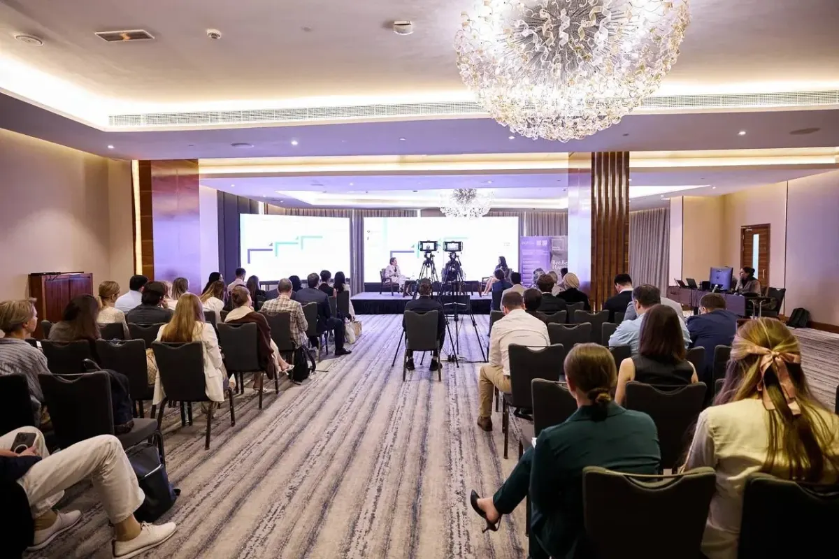 Audience in a conference room watching a panel discussion on international business and tax topics
