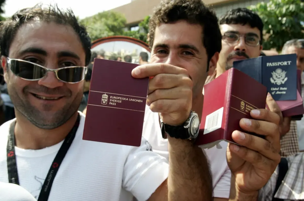 Smiling group holding European Union and US passports, suggesting couples with different citizenships and tax residency questions Smiling group holding European Union and US passports, suggesting couples with different citizenships and tax residency questions