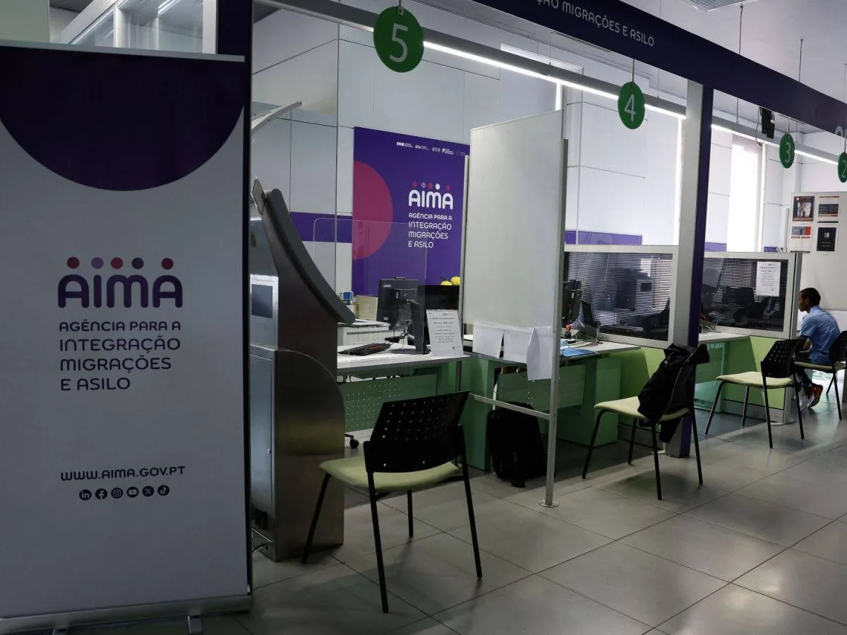 Portuguese AIMA service office with desks and numbered workstations, relevant for US consultants comparing residency options