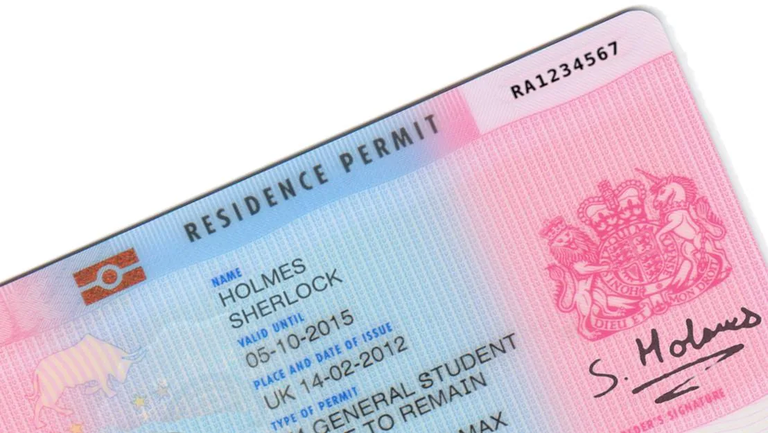 Residence permit card representing visa and residency considerations for long-term stays abroad